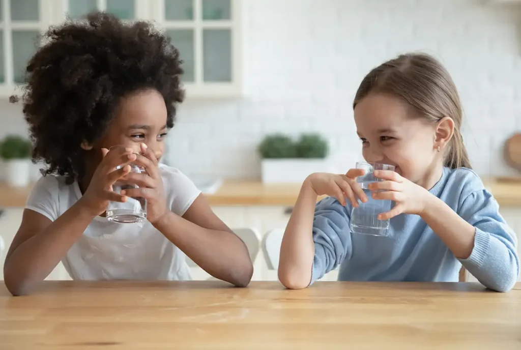 2 young girls drinking clean water out of glasses collinsville il
